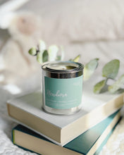 Load image into Gallery viewer, home decor with candle sitting on top of stack of books
